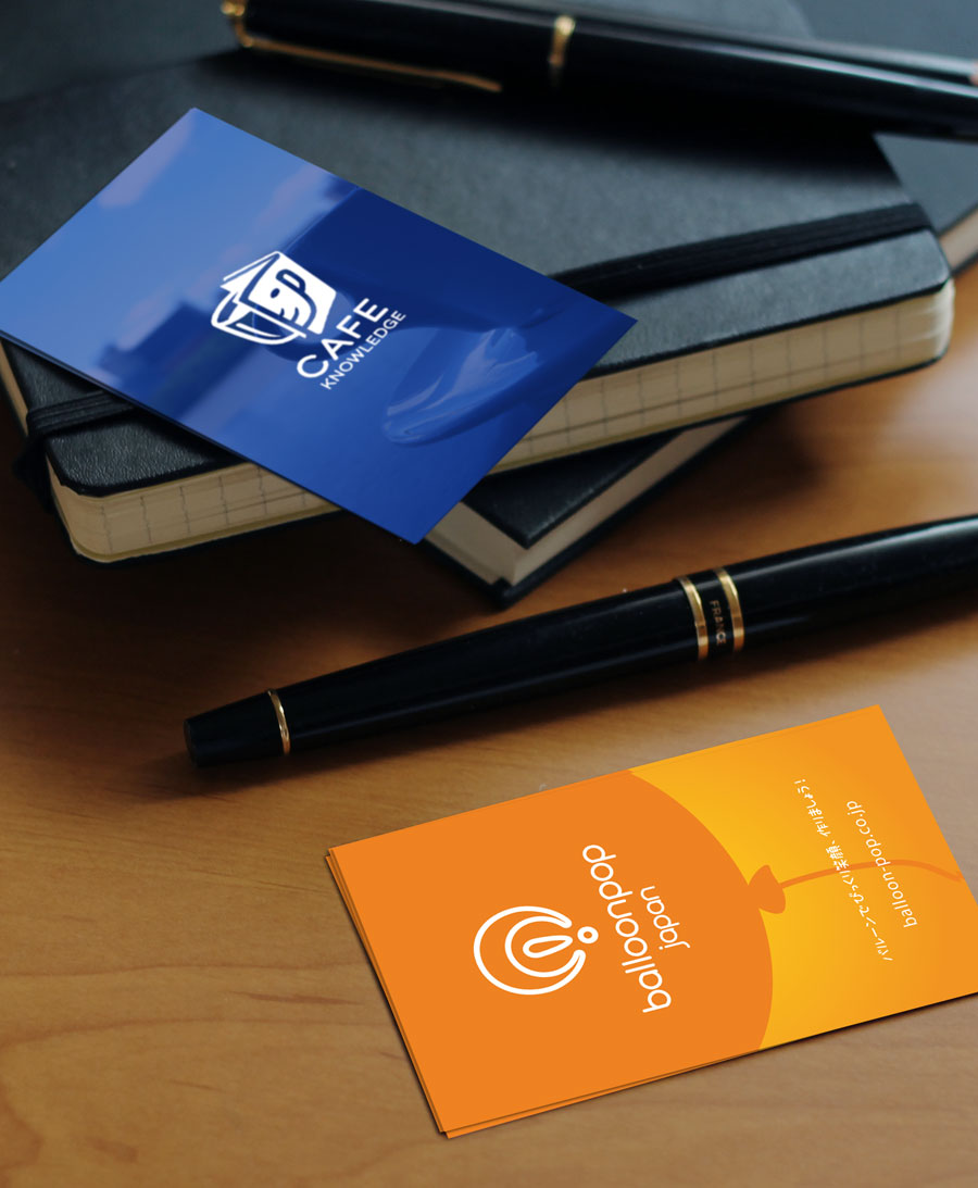 Business card samples designed by TMCreation displayed on a desk showing clean layouts and premium printing finish