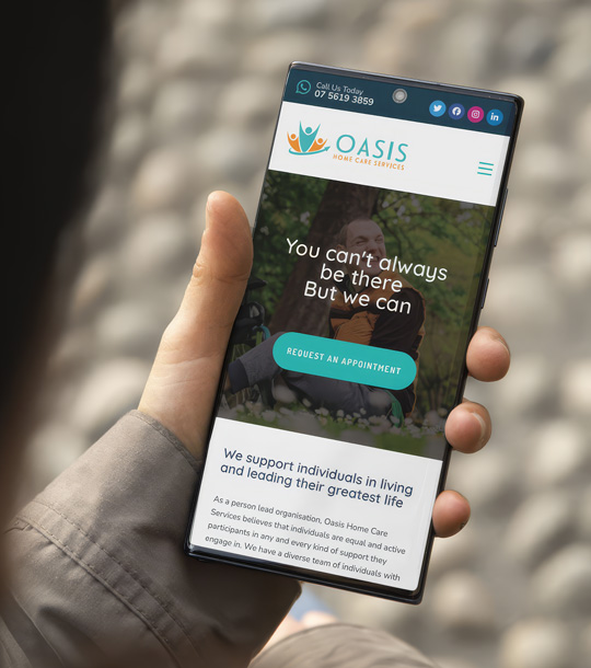 Laptop showing a website in a bright workspace with natural light and greenery, emphasising a calm modern design atmosphere and clear responsive layout