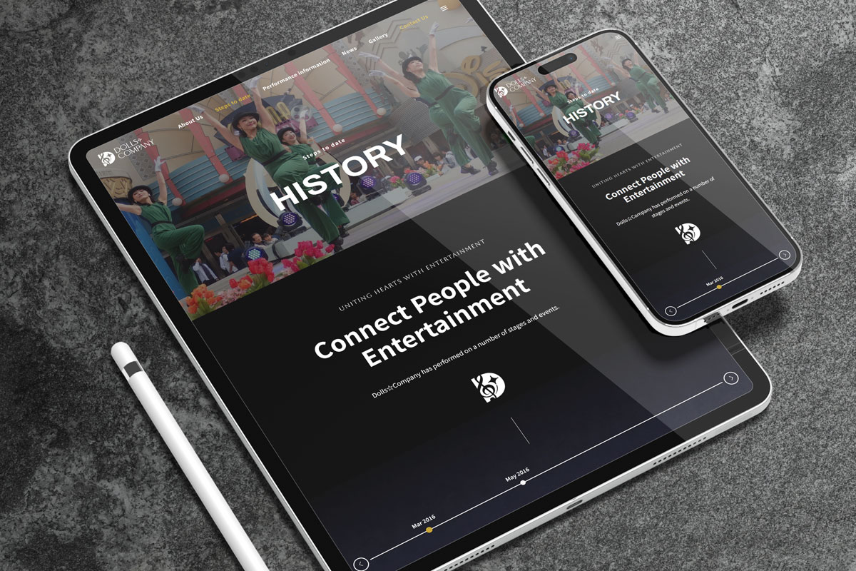 Tablet and smartphone displaying a modern dark themed website designed by TMCreation with crisp visuals and clean layout on a grey textured surface